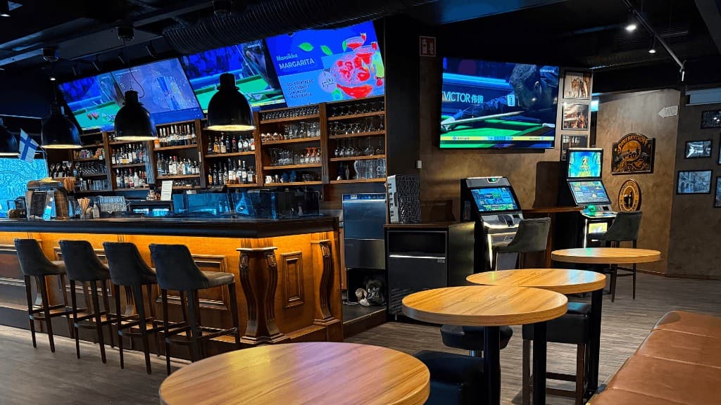 Bar interior with seating and screens